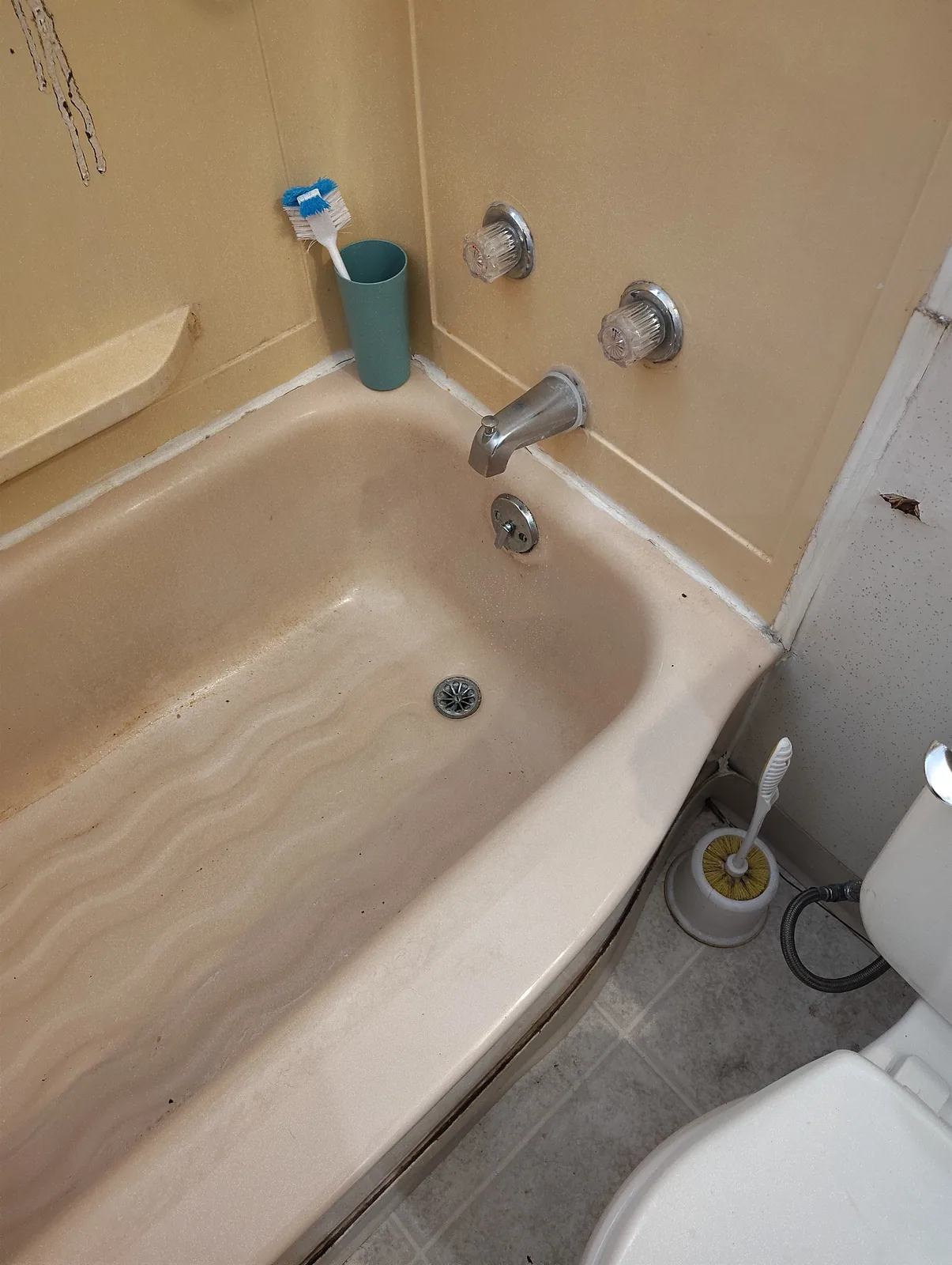 The same bathtub after the blockage was cleared and the water drained away