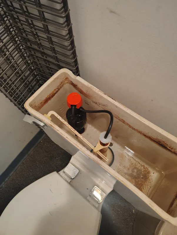 A new fill valve and flapper installed in the same toilet tank