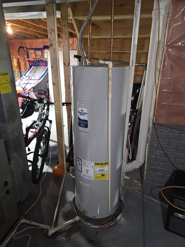 A water heater connected with new supply lines in a basement