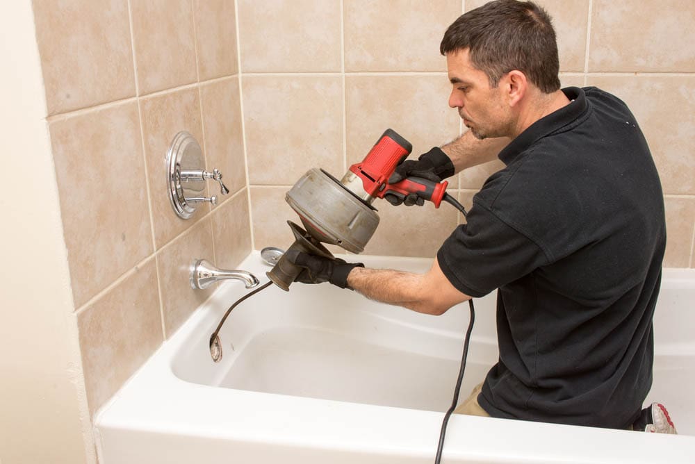 plumber snaking a drain Arlington, OH