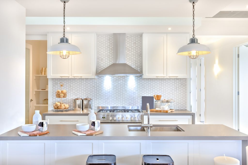 Bright modern kitchen with pendant lights and white cabinets