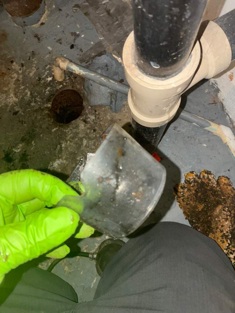 Plumber performing rooter services